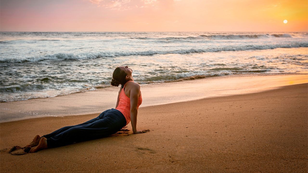 sunset yoga woman practicing yoga on the beach