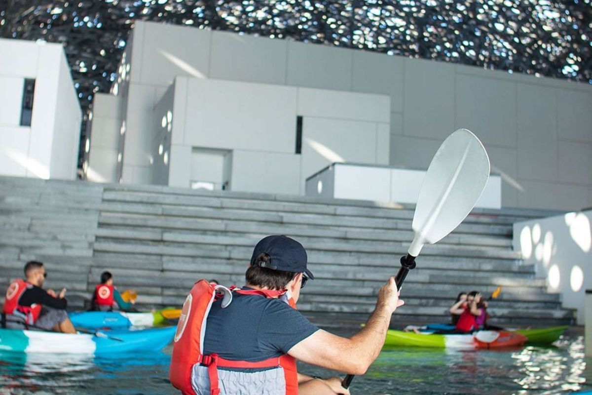 People kayaking at Louvre Abu Dhabi for things to do People kayaking at Louvre Abu Dhabi for things to do