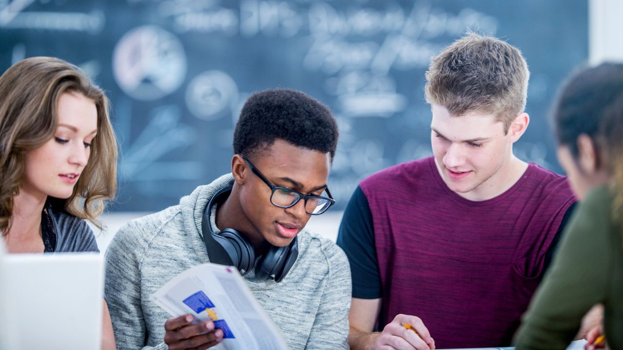 student students in classroom reading a book