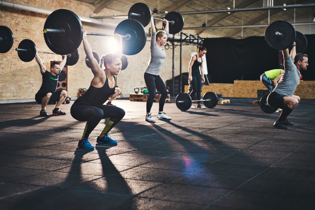 Gym people People lifting weights at the gym for a healthier lifestyle as advised by the obesity doctor from UE Medical Healthplus