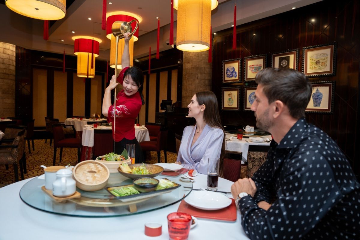 Dine with Shang Palace Traditional tea pouring for guests at Shang Palace, Shangri-La Qaryat Al Beri Abu Dhabi