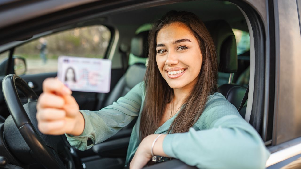 drivers license girl smiling with her drivers license