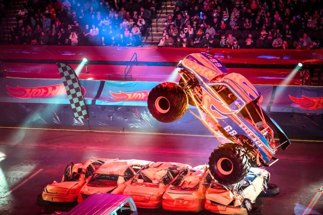 A Hot Wheel Monster Truck live glow crushing small cars underneath, going live this November in Etihad Arena